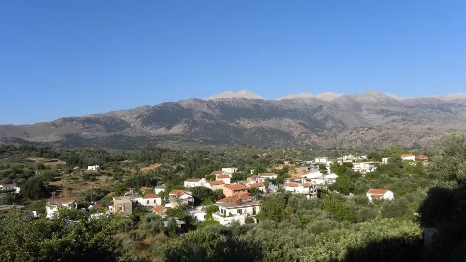 Village in a verdant valley with mountains, Chania region